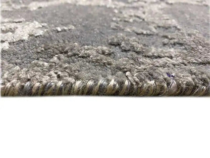 Gray heathered rug with a dense pile surface and a silvery border