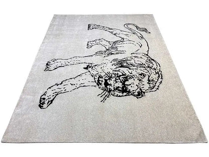 Designer rug in a rectangular format with a lying dog figure motif, light gray/black