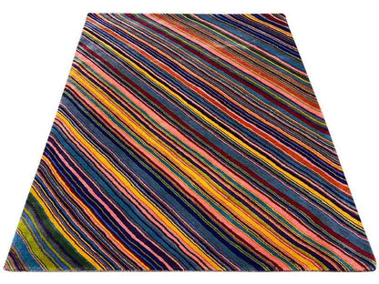 Round rug with an angled, multicolored stripe pattern, with blue as the main color