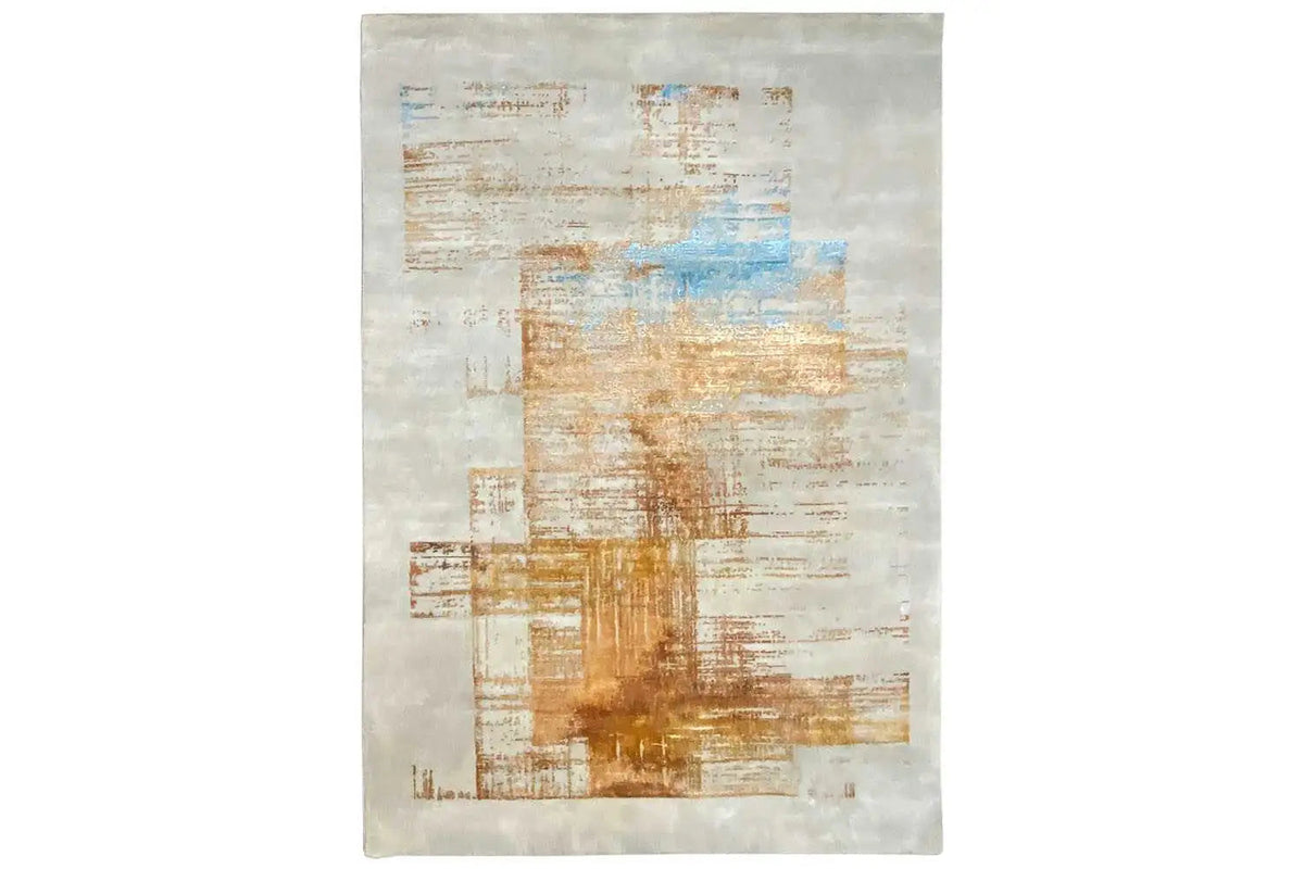 Designer rug in portrait format with an abstract pattern in cream, gold, and blue