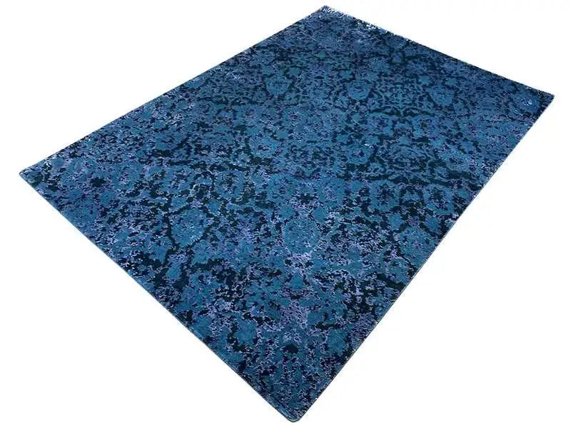 Rug with a dark blue, irregular pattern and a wide border.