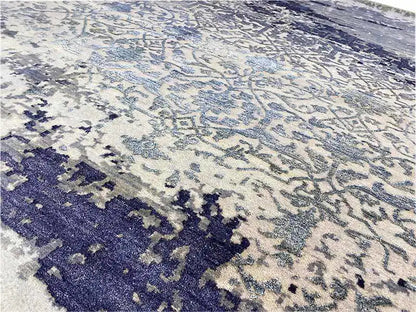 Close-up of the carpet: delicate ornamental pattern in light beige and dark blue