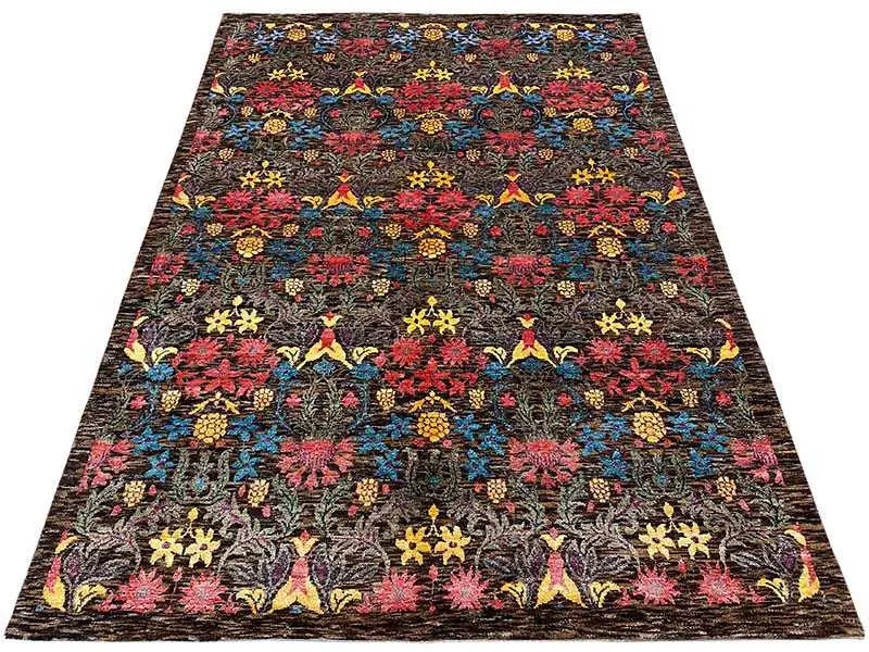 Large rectangular rug with a dense floral and ornamental pattern, dark pile