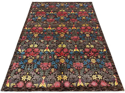 Large rectangular rug with a dense floral and ornamental pattern, dark pile