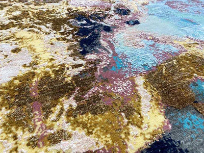 Close-up of the abstract carpet pattern with gold and turquoise accents
