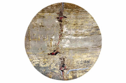 Round modern rug with a gray background, gold/brown abstract design, and red dots.
