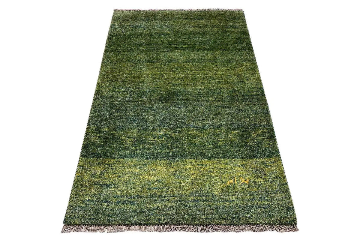 Gabbeh rug with a short pile, dark green and yellowish marbling, fringes