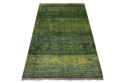 Gabbeh rug with a short pile, dark green and yellowish marbling, fringes
