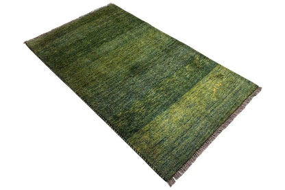 Gabbeh rug, green patterned with fringes along the edges, flatweave