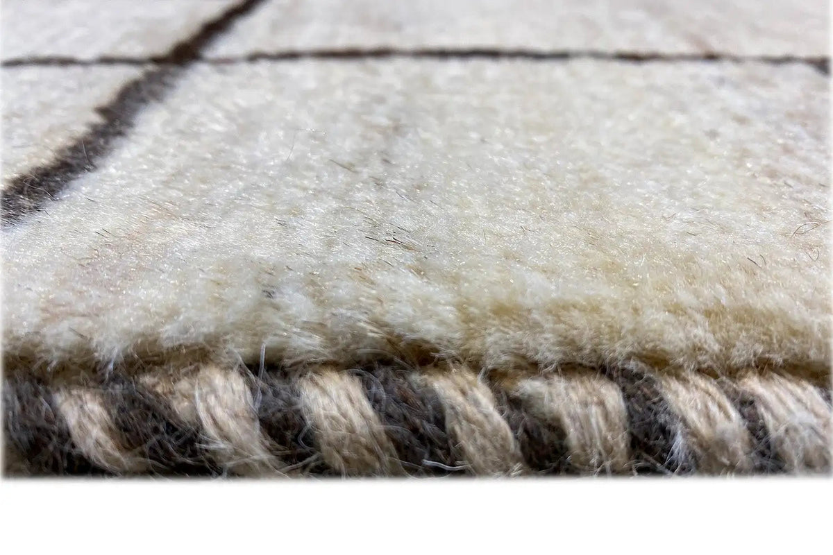 Gabbeh rug with a bound edge and short fringes, light beige surface
