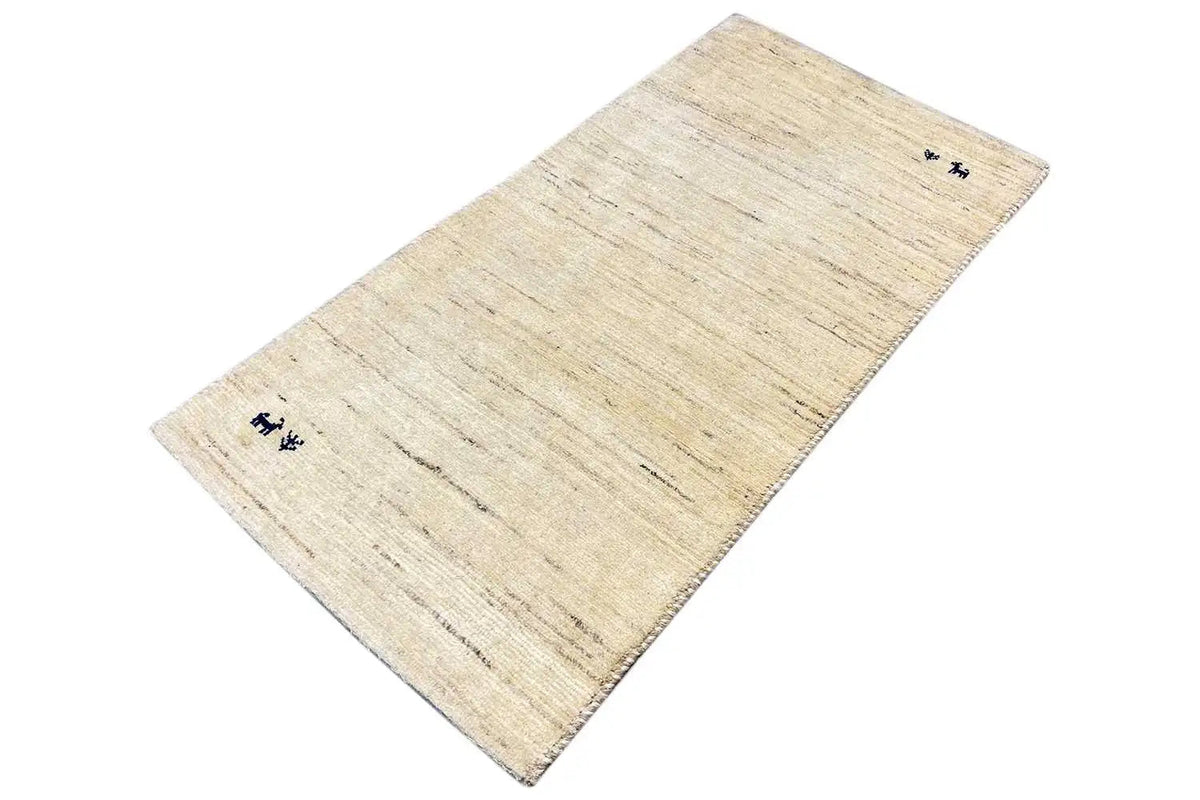 Beige Gabbeh rug with a diagonal view, light lines, and blue motifs