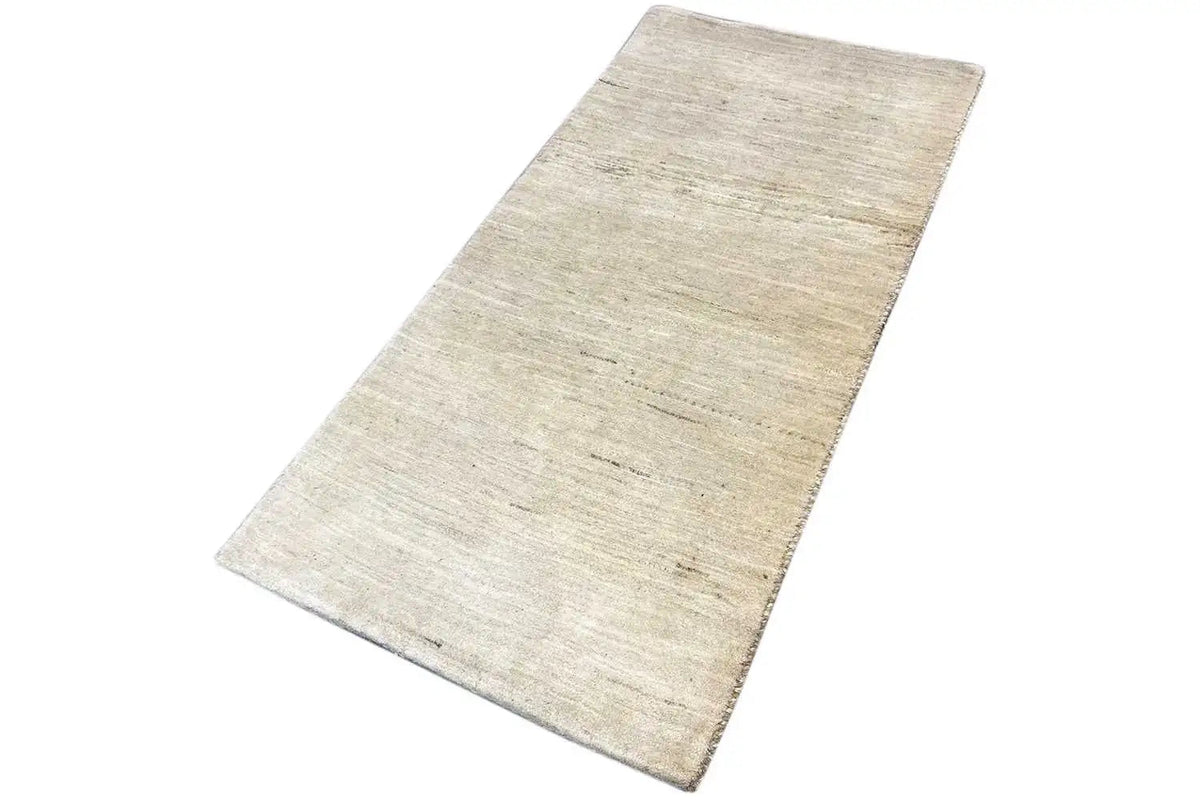 Light beige rectangular Gabbeh rug with an even linear pattern and texture