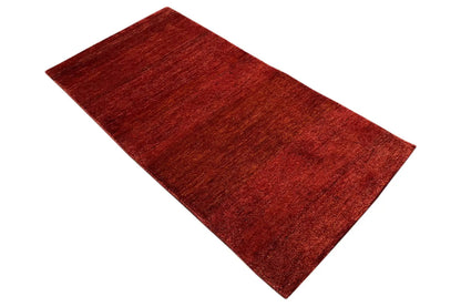 Rug, reddish brown, diagonal view of a rectangular flat weave