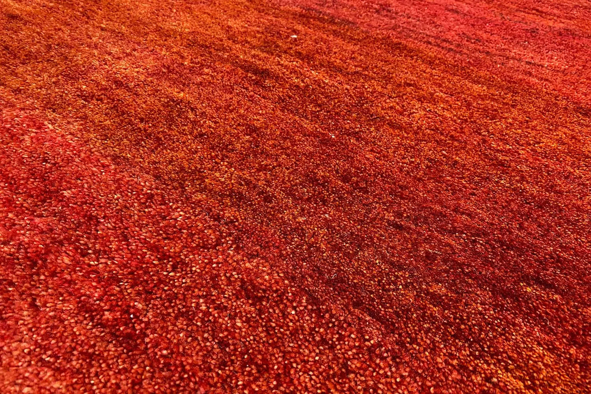 Carpet surface in reddish brown, fine fiber pattern with a dense, uniform weave structure