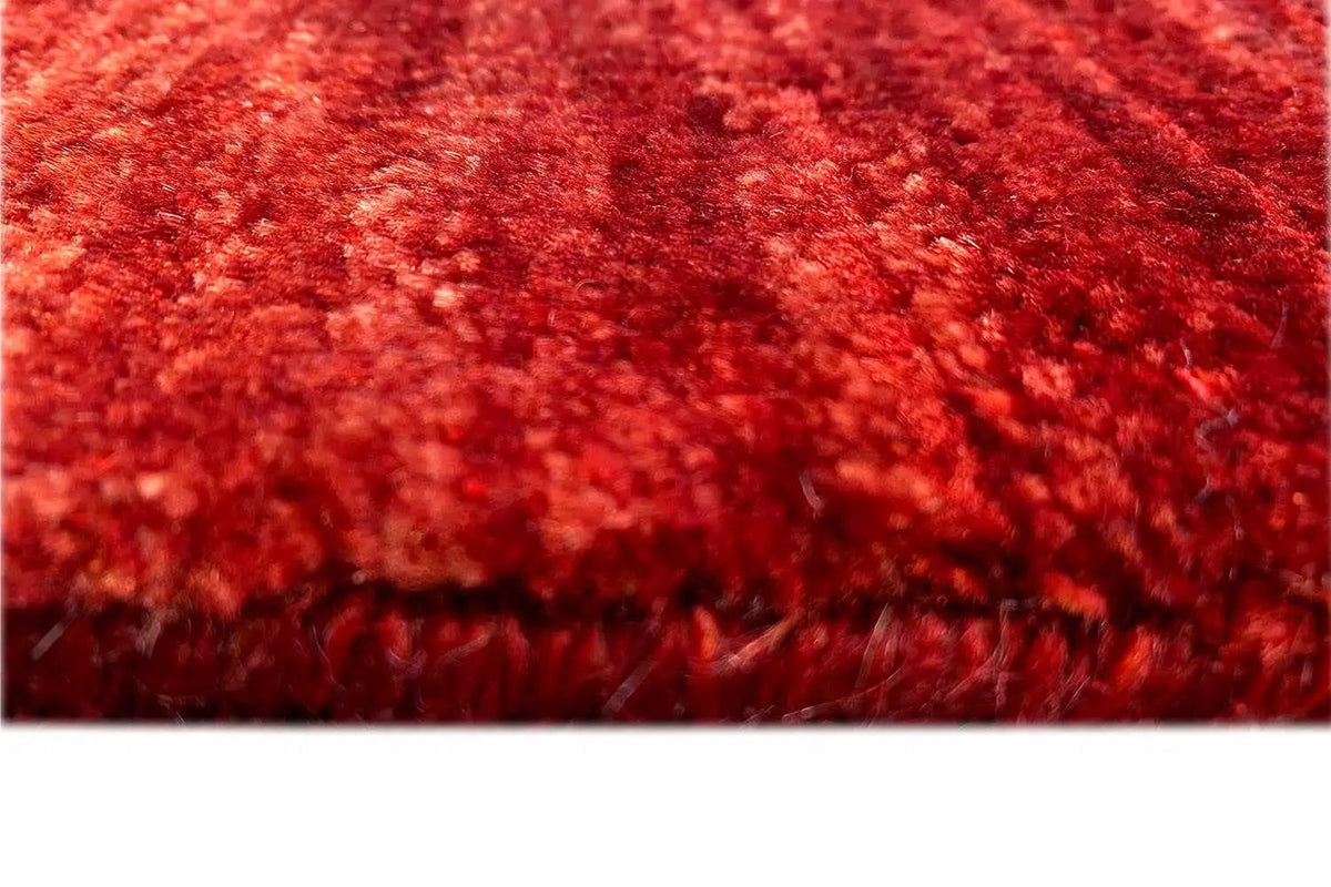 Detailed view: red carpet pile with a dense, irregular texture