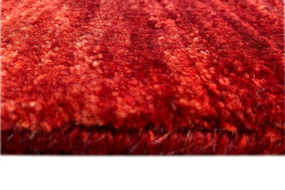 Detailed view: red carpet pile with a dense, irregular texture