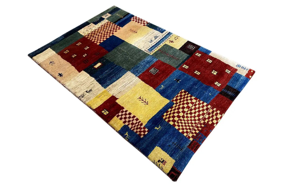 Gabbeh rug with square patchwork elements in blue, red, and yellow