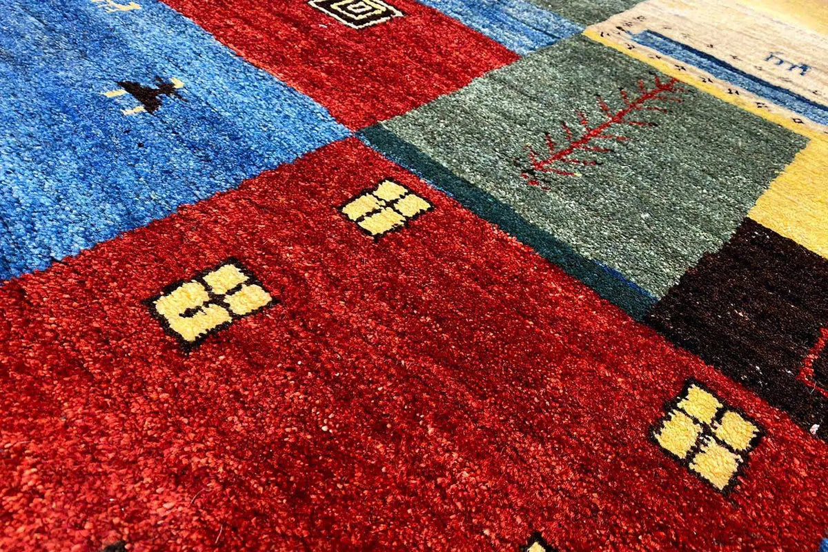 Carpet detail with a red background, blue areas, and yellow ornaments