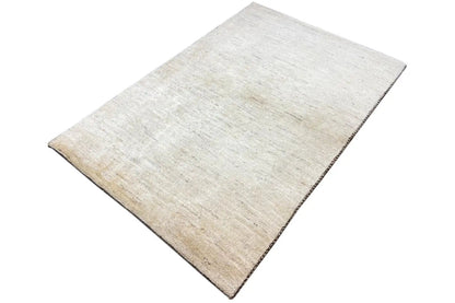Gabbeh rug 150x101 cm, cream-colored surface with a subtle patterned texture