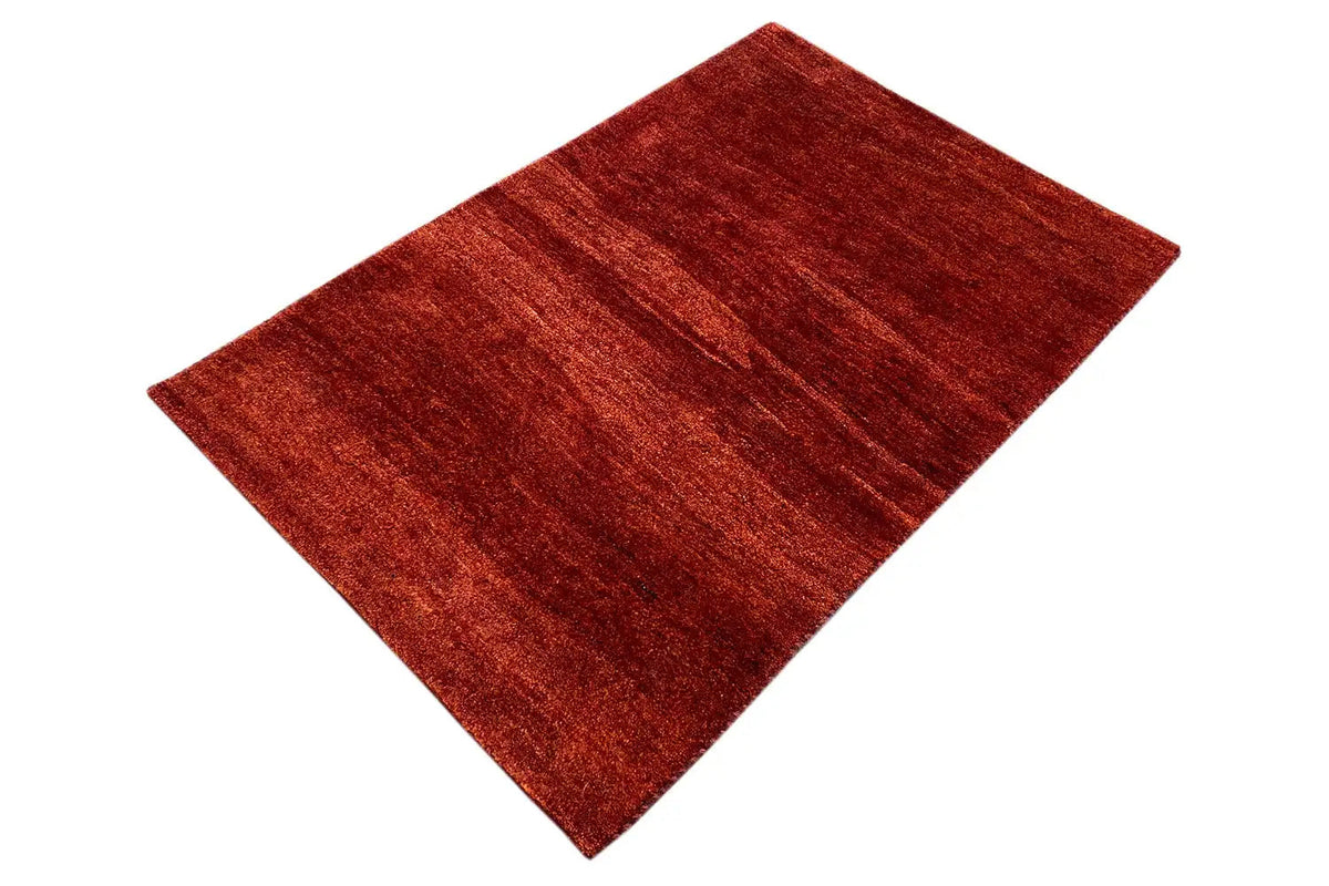 Gabbeh rug 118x82 cm, red pile, photographed at an angle, textured surface