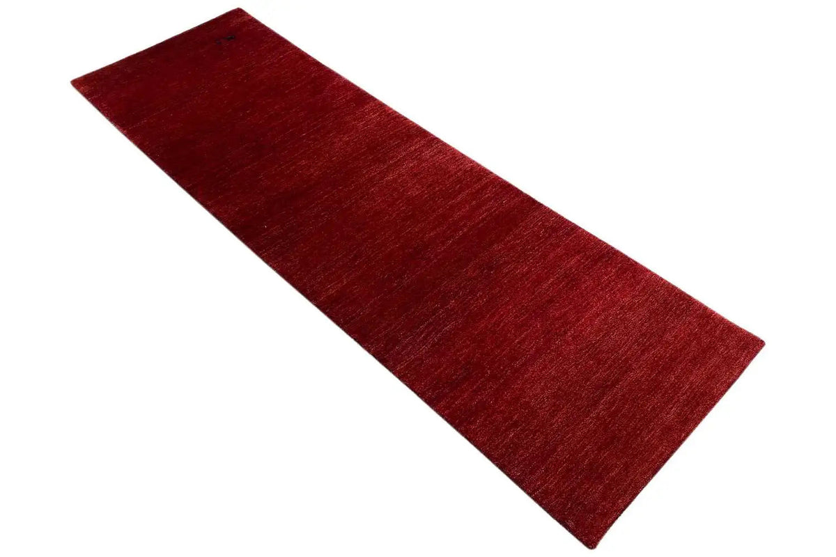 Narrow burgundy rug with a fine, irregular woven texture