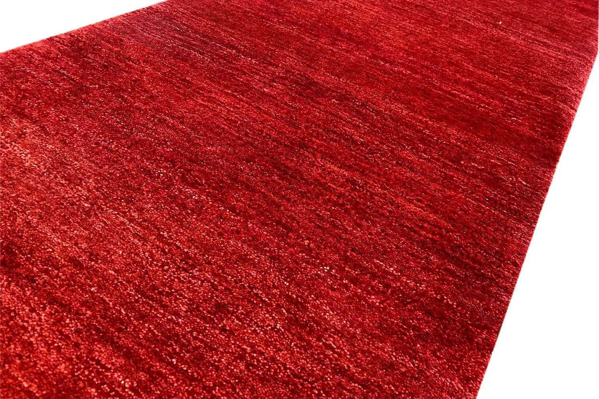Bordeaux-red carpet surface with a subtle mottled weave pattern