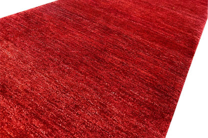 Bordeaux-red carpet surface with a subtle mottled weave pattern