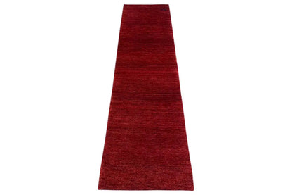 Gabbeh runner rug made of red yarn, narrow edges, mottled solid color