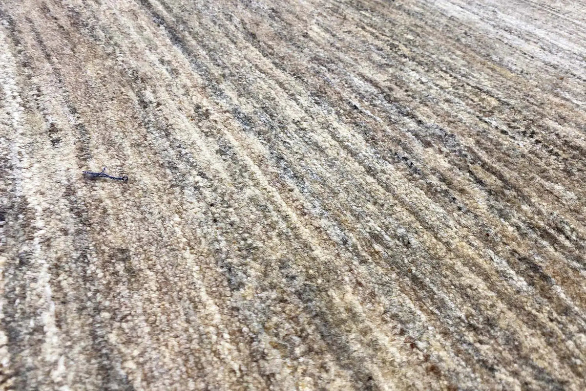 Gabbeh rug surface with fine beige and gray-brown lines