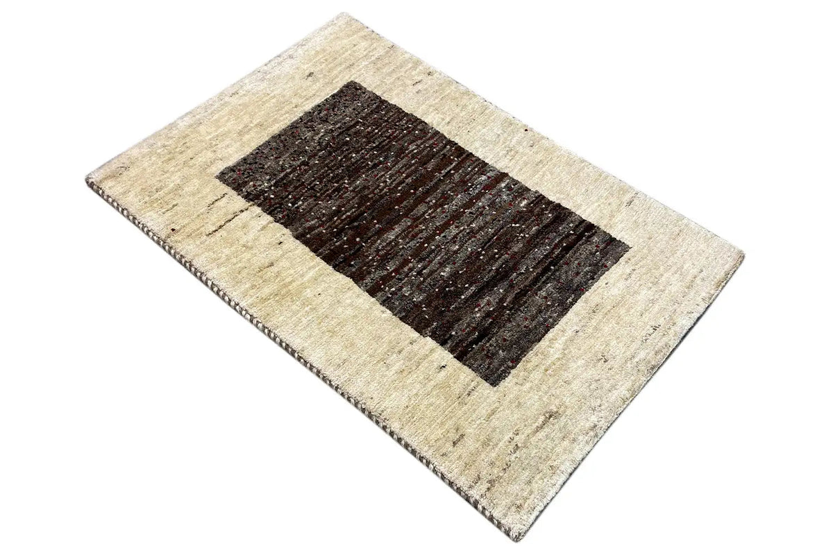 Gabbeh rug 87x55 cm, diagonal view with a beige border and dark area