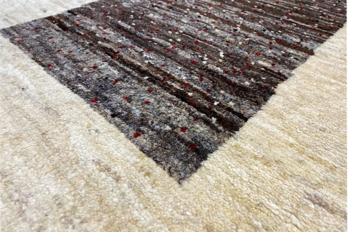 Gabbeh rug 87x55 cm close-up: beige weave with a dark, mottled pattern