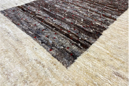 Gabbeh rug 87x55 cm close-up: beige weave with a dark, mottled pattern