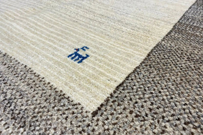 Carpet corner with a beige central field, gray border, and blue design