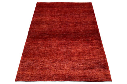 Gabbeh rug 151x106 cm, red woven rug in angled view, rectangular
