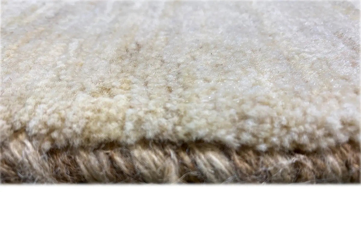 Gabbeh rug close-up, pile & selvedge, light beige with a short, dense texture
