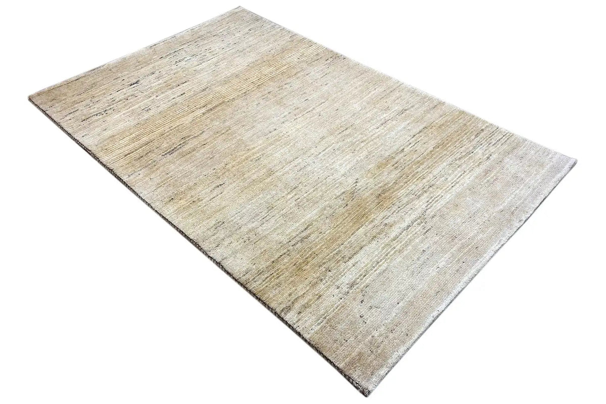 Gabbeh rug (184×118 cm) in a beige shade, diagonal view with edges
