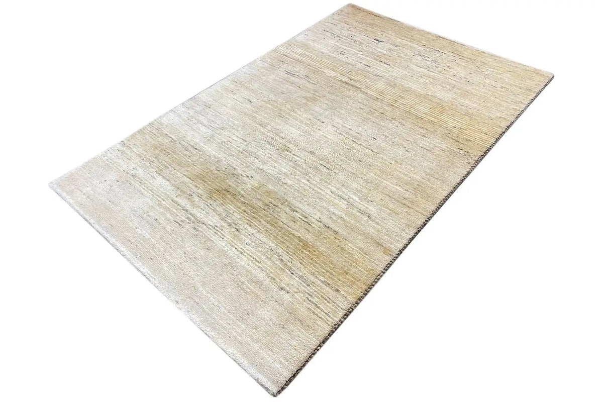 Gabbeh rug (184×118 cm), beige look, viewed from above at an angle with visible weave texture
