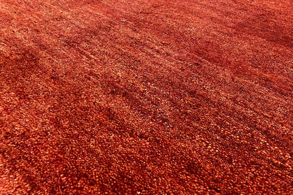 Gabbeh rug surface close-up: reddish-brown, dense low pile
