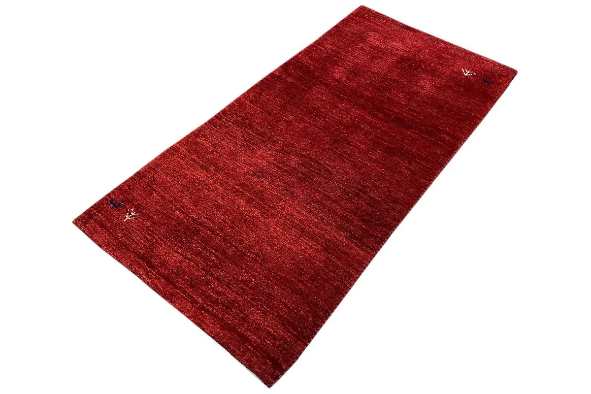 Red Gabbeh rug with fine grain, elongated top view