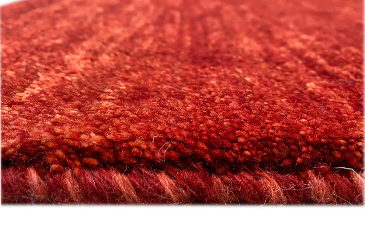 Close-up: red short-pile carpet with a visible edge