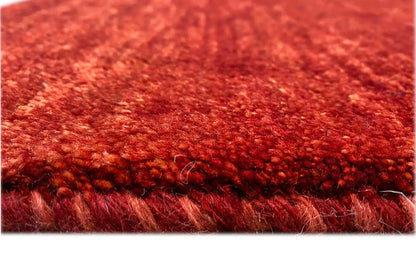 Close-up: red short-pile carpet with a visible edge