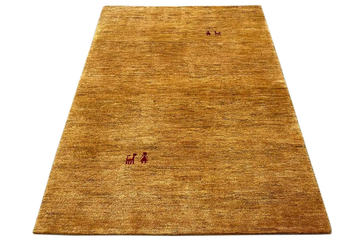 Golden-brown Gabbeh rug, spread out with small red motifs