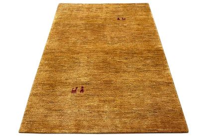 Golden-brown Gabbeh rug, spread out with small red motifs