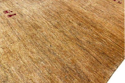Golden-brown Gabbeh rug, fine textures and small red medallions in detail
