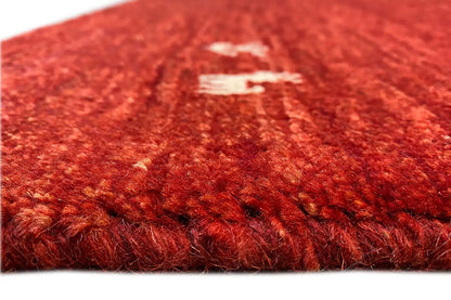 Gabbeh rug 142x69 cm, detail of the red pile texture with a light patterned area