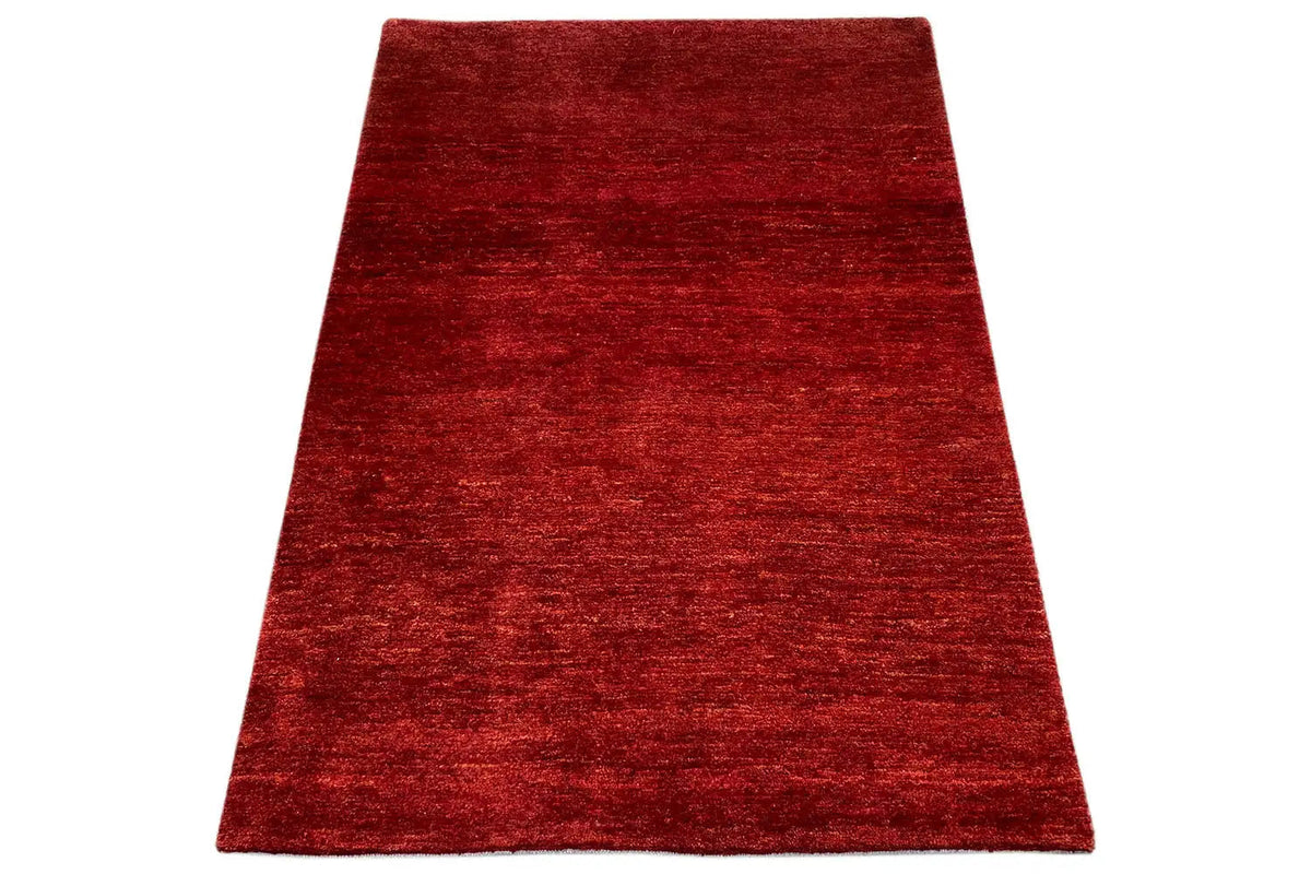 Gabbeh rug 112x81 cm, red rug viewed at an angle with an even pile