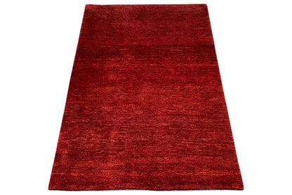 Gabbeh rug 112x81 cm, red rug viewed at an angle with an even pile