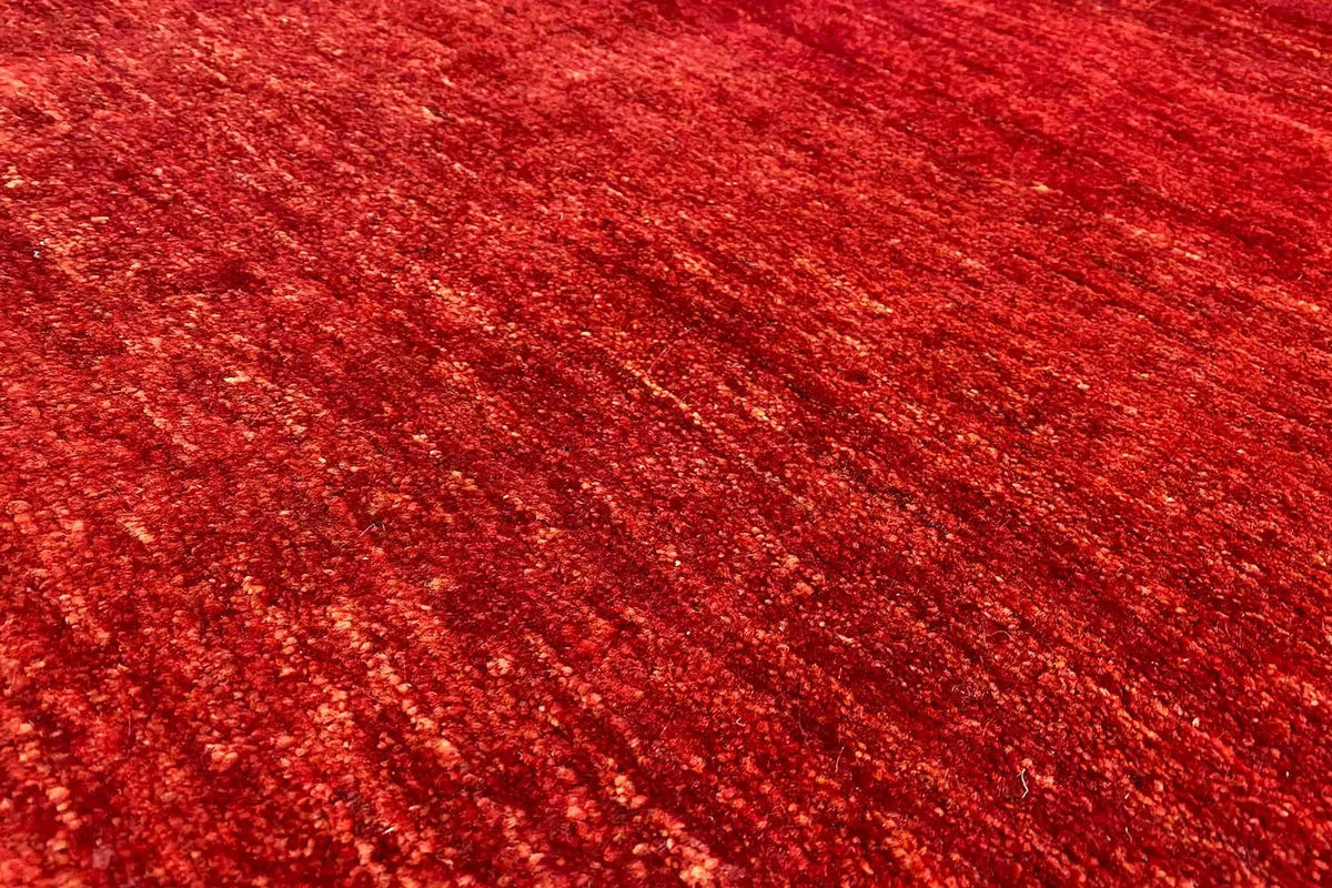 Gabbeh rug, close-up of a surface with a red, fine texture and marbling