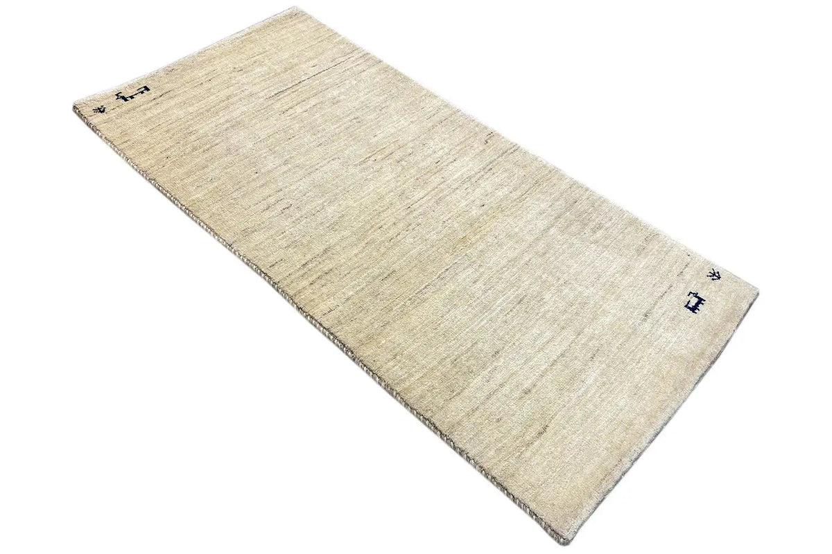 Gabbeh rug in light beige with delicate blue patterns, handwoven look
