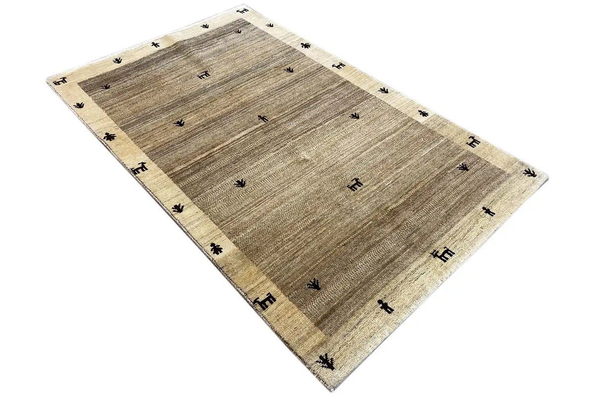 Gabbeh rug 181x116 cm, beige with a dark pattern and a subtle border.